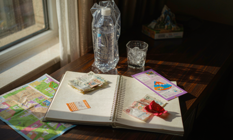 Travel budget notebook with cash and ski lift ticket in Xinjiang