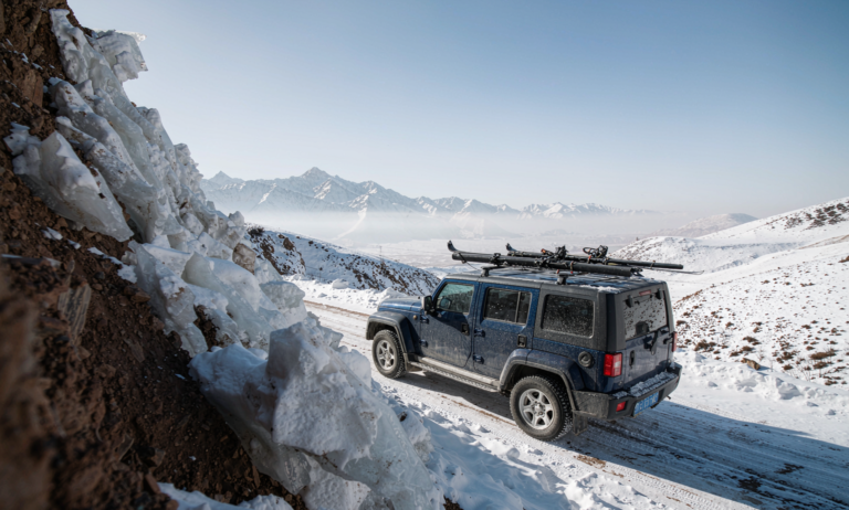 SUV with skis on a Xinjiang mountain road