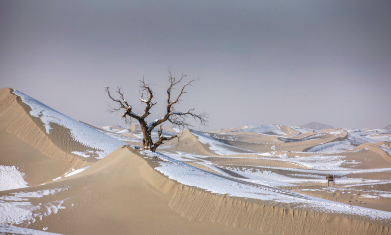 Snow on the sand dunes of the Gurbantunggut Desert near Urumqi, Xinjiang