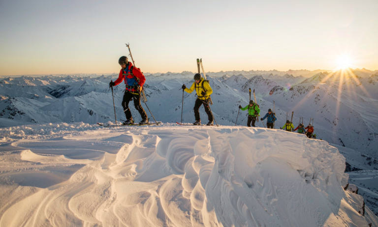 Skimo racers ascending a Xinjiang peak